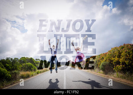 Image composite de l'heureux couple jumping on the road Banque D'Images