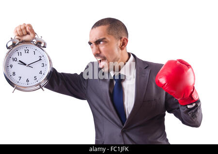 Angry businessman frapper réveil isolated on white Banque D'Images