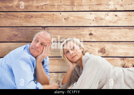 Image composite de mature couple lying et pensée Banque D'Images