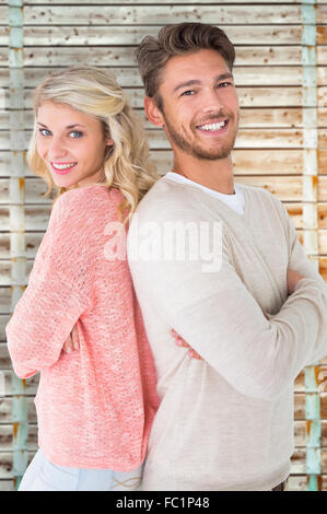 Composite image couple smiling with arms crossed Banque D'Images