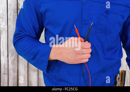 Image composite de electrician holding multimètre Banque D'Images