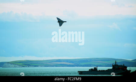 Bombardier Vulcan avions survolaient le navire militaire dans la baie de Bournemouth avec les collines de Purbeck dans l'arrière-plan photographié en 2015 Banque D'Images