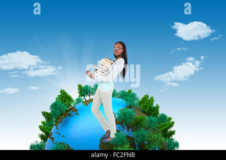 Composite image de jeune femme portant une pile de livres Banque D'Images