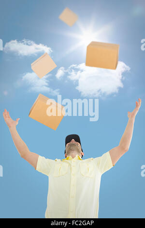 Image composite de delivery man with arms raised Banque D'Images