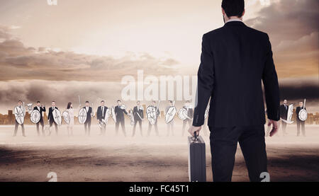 Composite image of businessman holding a briefcase Banque D'Images