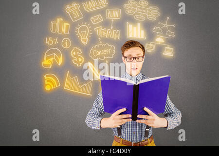 Image composite de geeky businessman reading a book Banque D'Images