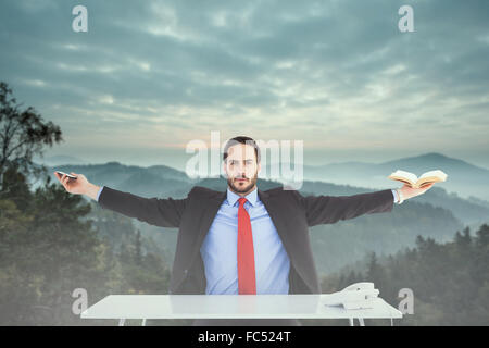 Composite image of businesswoman sitting with arms outstretched Banque D'Images