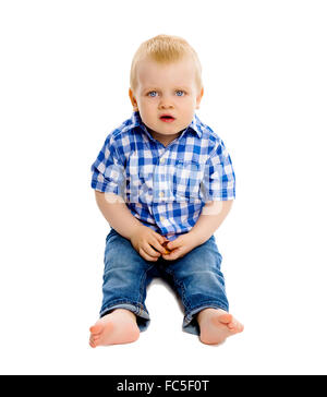 Petit garçon dans une chemise à carreaux et jeans Banque D'Images