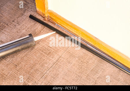 Application d'un pistolet à calfeutrer Banque D'Images