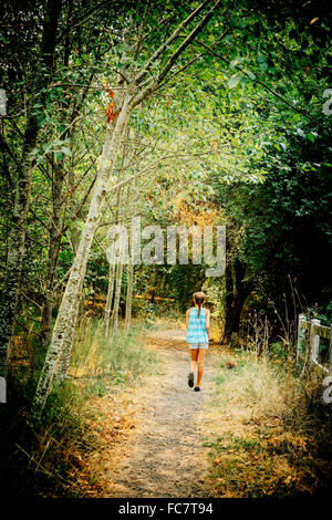 Mixed Race girl walking on dirt path Banque D'Images