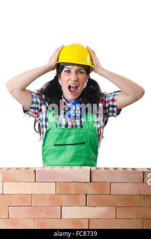 Angry female construction worker on white Banque D'Images