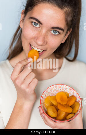 Woman eating dry abricot. Banque D'Images