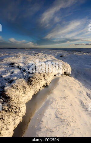 Moorland Snowy à côté du Pennine Way dans le Derbyshire Glossop ci-dessus sur une magnifique soirée d'hiver au coucher du soleil. Banque D'Images