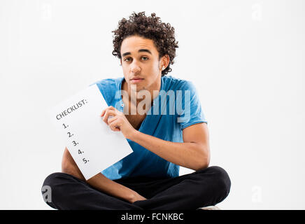 Smart Guy montre une liste de contrôle sur une feuille parce qu'un esprit organisé fait un bon travail Banque D'Images