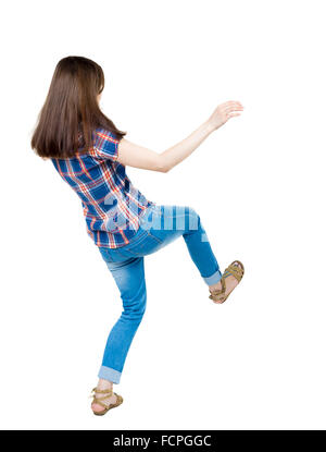 Retour voir les soldes femme en agitant les bras. L'article jeune fille en jeans. Vue arrière Vue arrière. collection les gens de personne. Plus isolé sur fond blanc. Une jeune fille dans une tunique bleue avec bandes rouges à l'arrière de la chute Banque D'Images