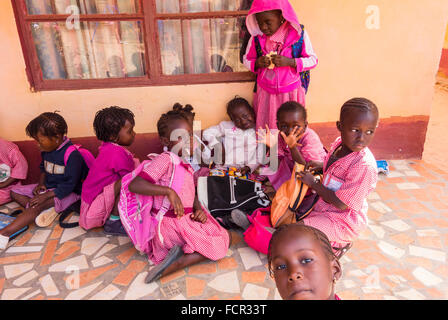 Pause déjeuner pour les enfants en bas noir à un organisme de bienfaisance fonctionner l'école dans les rues de Gambie Kololi Banque D'Images