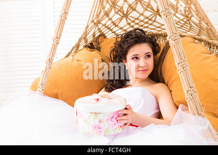 Jours fériés, présente, mariage et bonheur concept - smiling woman in white dress holding gift box Banque D'Images