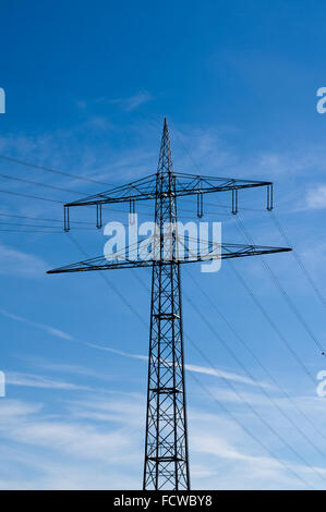 Pylônes à haute tension contre le ciel bleu avec des nuages Banque D'Images