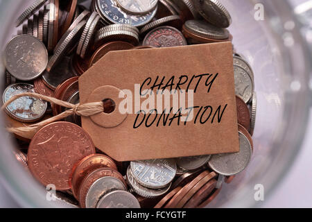 Don de bienfaisance britannique sur l'étiquette à l'intérieur des pièces mixtes un bocal de verre concept Banque D'Images