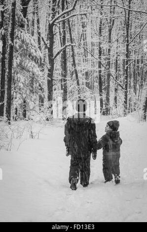 Deux frères prendre une marche dans un sentier dans une tempête, petit frère regarde son grand frère. Banque D'Images