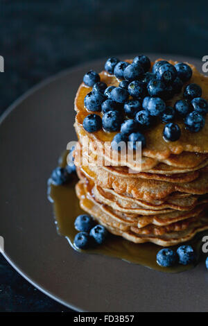 Pile de crêpes épeautre garnie de sirop d'érable et bleuets frais Banque D'Images