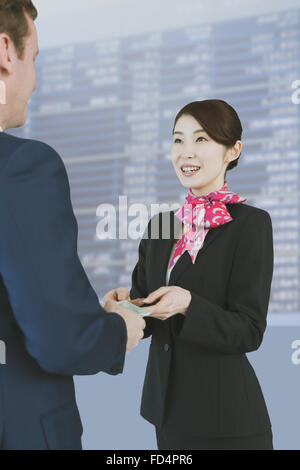 Hôtesse de l'attrayant japonais d'aide aux clients à l'aéroport. Banque D'Images