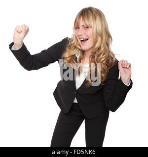 Young businesswoman célébrer une victoire ou de réussite et d'encouragement l'air frappe avec ses poings, on white Banque D'Images