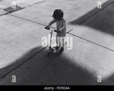 Portrait Of Boy Riding Scooter Push