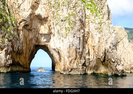 Un bateau de tourisme en passant par la roche dans l'île de Capri Banque D'Images