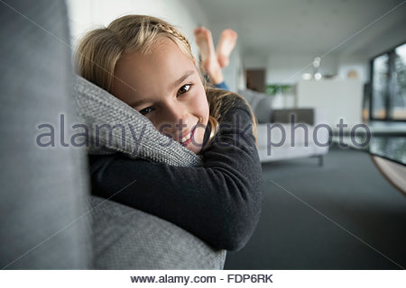 Portrait smiling girl laying on sofa