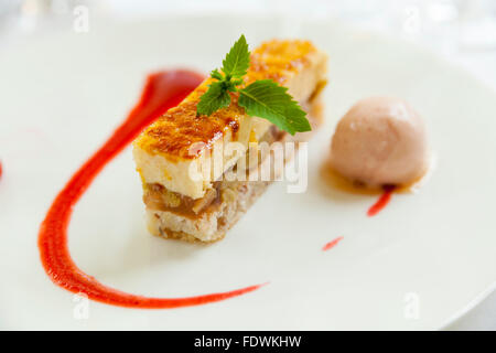 Tranche de tarte aux pommes avec sauce aux fraises et sorbet au citron Banque D'Images