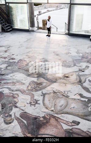 Woman stands avec parquet mosaïque romaine dans la Villa Romana del Casale, Piazza Armerina, Sicile, Italie Banque D'Images