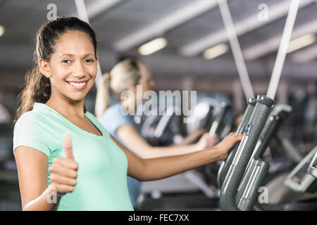 Smiling pregnant woman on crosstrailer showing thumb up Banque D'Images