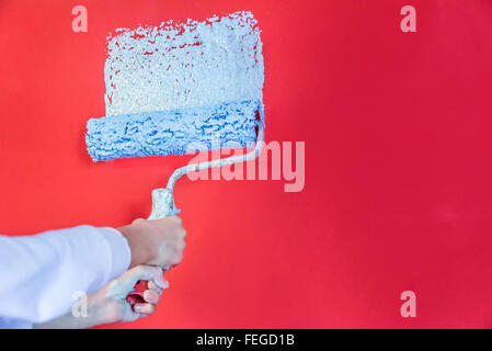 Fillette de huit ans la peinture du mur à la maison Banque D'Images