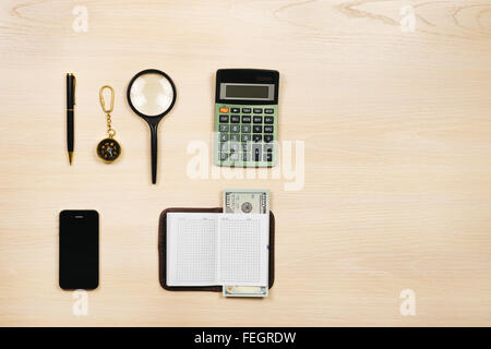 Ensemble d'articles de voyage y compris loupe, boussole, calculatrice, stylo, ordinateur portable, téléphone mobile et de l'argent. Planification d'overhea Banque D'Images