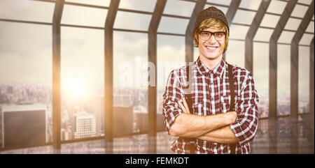 Composite image of smiling blonde hipster crossing arms Banque D'Images