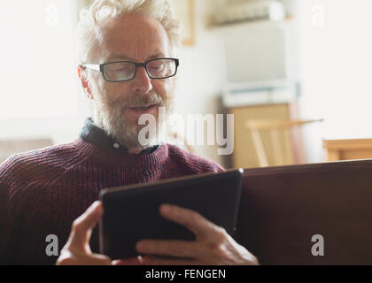 Senior man with eyeglasses using digital tablet Banque D'Images