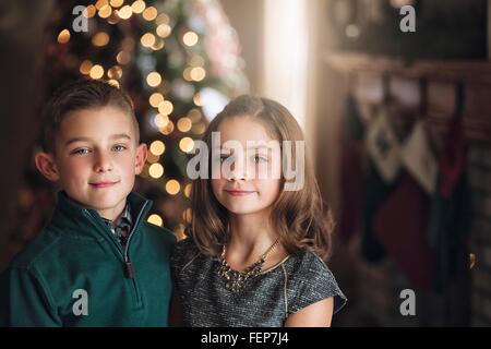 Portrait of boy in front of Christmas Tree smiling at camera Banque D'Images