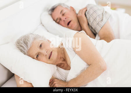 Awake senior woman in bed Banque D'Images