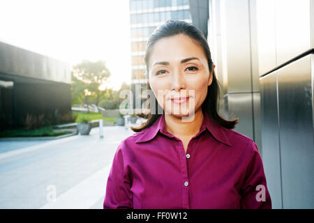 Asian businesswoman smiling outdoors Banque D'Images