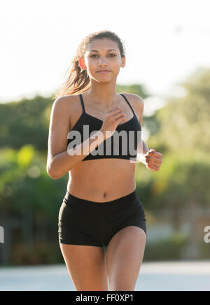 Mixed Race woman running outdoors Banque D'Images