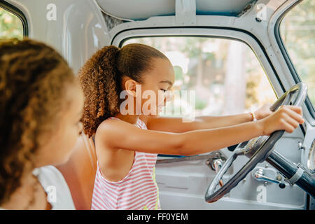 Mixed Race girl driving in car Banque D'Images