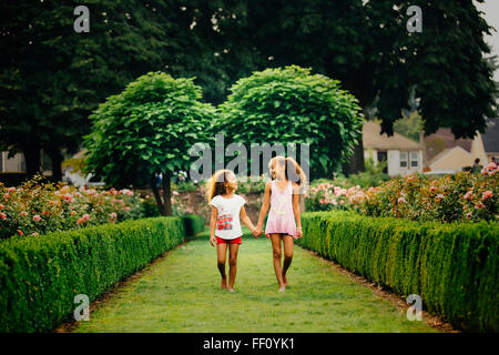 Mixed Race girl walking in garden