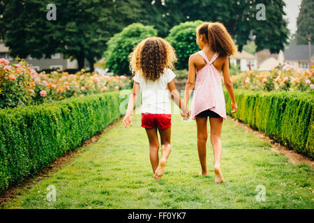 Mixed Race girl walking in garden