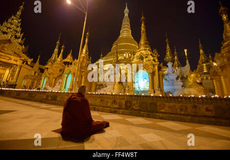 Un moine en prière à la pagode Shwedagon Paya, le saint pèlerinage de Yangon, Myanmar Banque D'Images