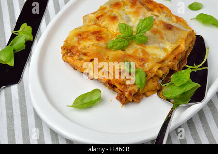 Lasagnes de feuilles de basilic servi sur une assiette avec une fourchette à côté Banque D'Images