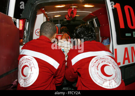 Le personnel de transport médical d'urgence lever un patient sur une civière dans une ambulance de l'hôpital Al Maqassad à Jérusalem. Médecins du Monde (MDM) et le Croissant-Rouge palestinien ont mis en place le transport d'urgence et premiers soins formation communautaire en Cisjordanie depuis le mur a été construit et a coupé l'accès facile pour les hôpitaux de Jérusalem. Banque D'Images