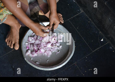 Mumbai, Inde - le 28 octobre 2015 - coupe femme piment et oignons sur un tabouret dans la coupe traditionnelle cuisine indienne Banque D'Images
