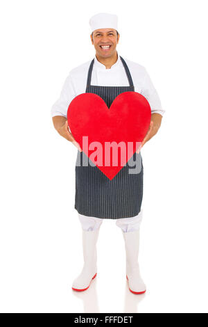 Portrait of mid age butcher holding heart isolated on white Banque D'Images