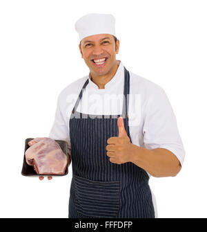 Cheerful mid age butcher holding meilleure qualité de viande Banque D'Images